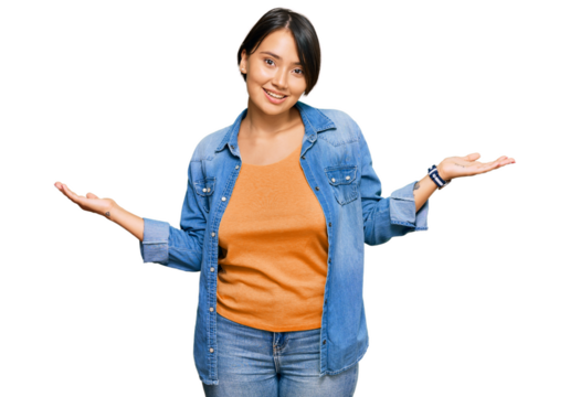 Young beautiful hispanic woman with short hair wearing casual denim jacket smiling showing both hands open palms, presenting and advertising comparison and balance - Powered by Adobe