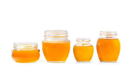 jars with honey one on top of the other on a white background