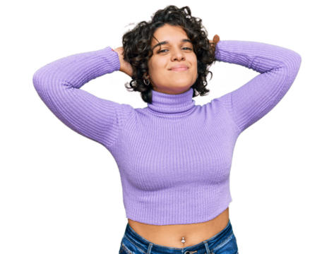 Young hispanic woman with curly hair wearing casual clothes relaxing and stretching, arms and hands behind head and neck smiling happy