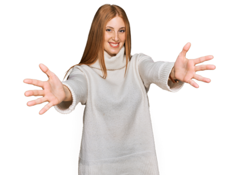 Young irish woman wearing casual winter sweater looking at the camera smiling with open arms for hug. cheerful expression embracing happiness.