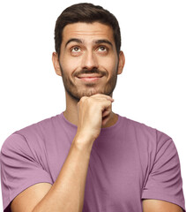 Young man in pink t-shirt with dreamy cheerful expression, thinking, looking up, dreaming