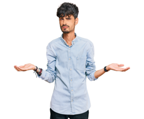 Young hispanic man wearing casual clothes clueless and confused with open arms, no idea concept.