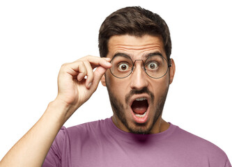 Angry young man shouting, displeased with bad behaviour, holding round glasses with hand