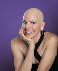 Portrait smiling mature woman survivor with hair loss isolated on purple background - 549123487