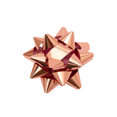 Golden rose or copper color christmas bow ribbon isolated from white background. Clipping path included.
