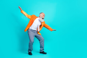 Full length photo of excited pretty retired man dressed bright orange jacket dancing discotheque...