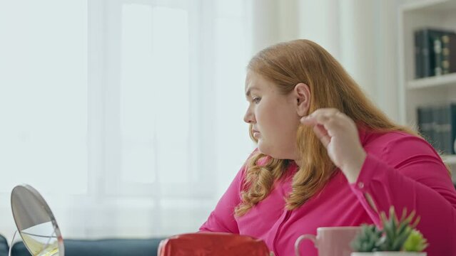 Young curvy woman feeling insecure about her appearance, self-conscious