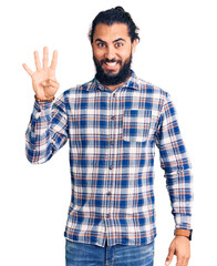 Obraz premium Young arab man wearing casual clothes showing and pointing up with fingers number four while smiling confident and happy.