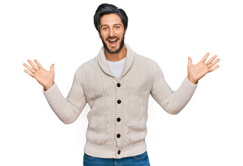 Young hispanic man wearing casual clothes celebrating victory with happy smile and winner expression with raised hands