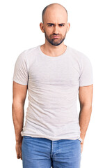 Young handsome man wearing casual t shirt depressed and worry for distress, crying angry and afraid. sad expression.