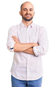 Young handsome man wearing elegant shirt happy face smiling with crossed arms looking at the camera. positive person.