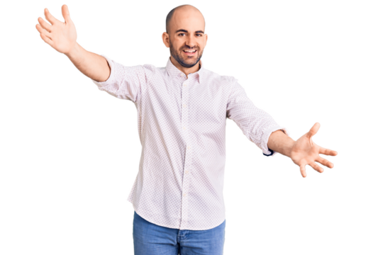 Young handsome man wearing elegant shirt looking at the camera smiling with open arms for hug. cheerful expression embracing happiness. - Powered by Adobe