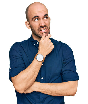 Young hispanic man wearing casual clothes thinking worried about a question, concerned and nervous with hand on chin