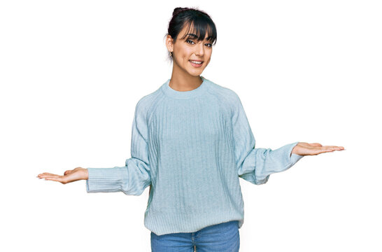 Young hispanic woman wearing casual clothes smiling showing both hands open palms, presenting and advertising comparison and balance