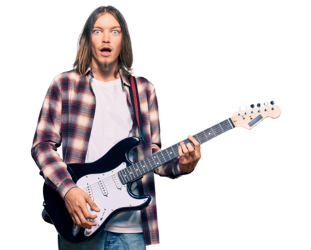 Handsome caucasian man with long hair playing electric guitar scared and amazed with open mouth for surprise, disbelief face