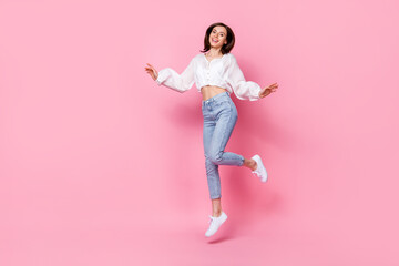 Full length photo of cheerful pretty lady wear nice clothes rejoice shopping sale empty space isolated on pink color background