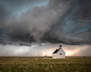 Severe thunderstorm over a rural church in the countryside. The church is in an open field with...
