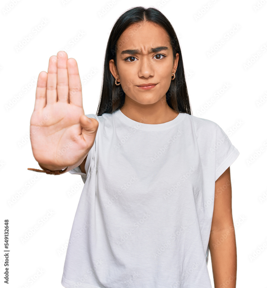 Wall mural Young asian woman wearing casual white t shirt doing stop sing with palm of the hand. warning expression with negative and serious gesture on the face. - Wall murals