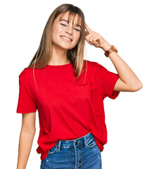 Fototapeta premium Teenager caucasian girl wearing casual red t shirt smiling pointing to head with one finger, great idea or thought, good memory
