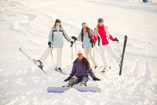 Group Of Girls Spend Time Together Skiing In Mountains