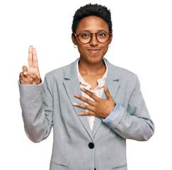 Young african american woman wearing business clothes smiling swearing with hand on chest and...