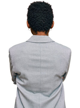 Young african american woman wearing business clothes standing backwards looking away with crossed arms