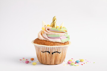 Cute sweet unicorn cupcake on white background