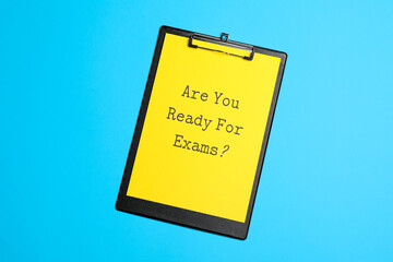 Paper with question Are you ready for exams on light blue table, top view