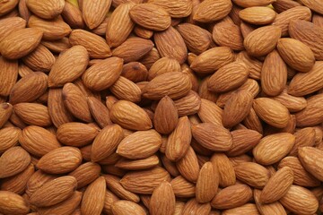 Delicious raw ripe almonds as background, top view