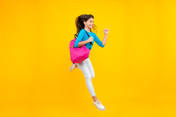 Fototapeta na wymiar School girl with backpack. Teenager student, isolated background. Learning and knowledge. Go study. Run and jump. Children education concept. Happy teenager portrait. Smiling girl.