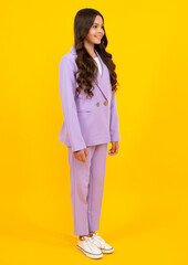 Full length of cheerful teenager child girl wearing comfy trendy fashion clothes, isolated over yellow background. Fashion kids suit. Happy teenager, positive and smiling emotions of teen girl.