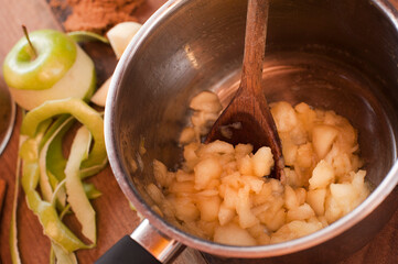 Authentic apple cooking close up with saucepan