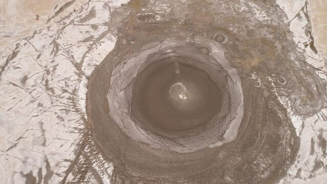 Mud volcano with bursting bubble bledug kuwu, slow motion. aerial view volcanic plateau with geothermal activity and geysers, Indonesia java. aerial view volcanic landscape