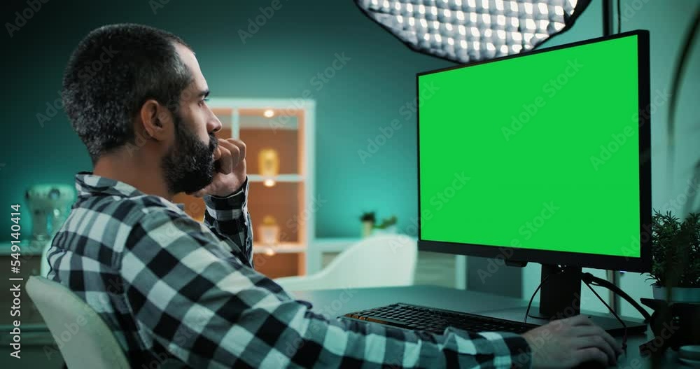 Poster professional data analyst at home office studio. working on desktop computer with chroma key green s