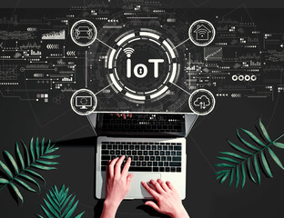 IoT theme with person using a laptop computer