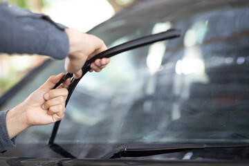 Technician replacing windshield wipers change car wiper blades - obrazy, fototapety, plakaty