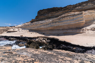 Huge coastal bay abyss with steep white coastal plateau, Fuerteventura west coast, Spain