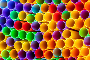 Heap of colorful plastic straws for drinks as background, closeup view macro plastic tubes, Fancy straw multicolor background