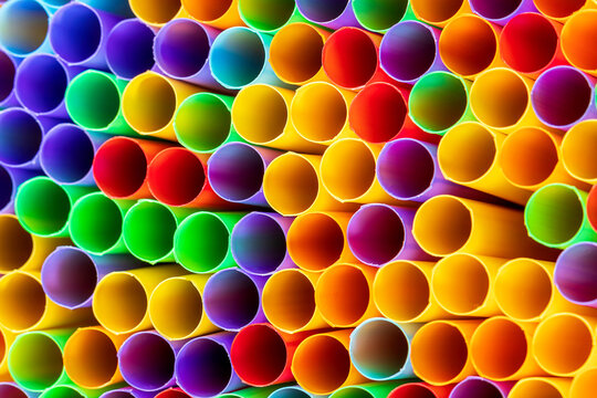 Heap of colorful plastic straws for drinks as background, closeup view macro plastic tubes, Fancy straw multicolor background