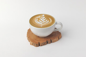 Hot milk coffee, espresso cafe Latte espresso with rosetta latte art in white ceramic cup (mug) on wood saucer isolated in white background.