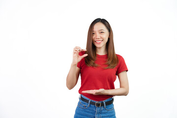 Pretend to hold small objects, Pretty Asian people wearing red t-shirt for a woman isolated on...