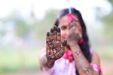 Indian Bride with traditional henna on hands. Mehendi Ceremony. Henna art tattoo wedding design....