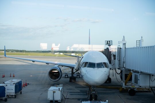 White airplane at Jacksonville Airport terminal, getting ready to board