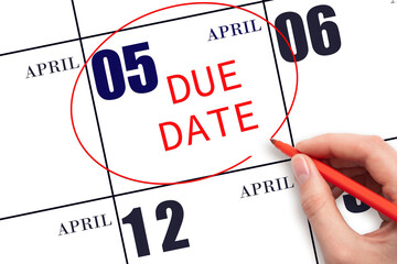 Hand writing text DUE DATE on calendar date April 5 and circling it. Payment due date