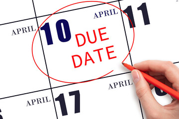 Hand writing text DUE DATE on calendar date April 10 and circling it. Payment due date