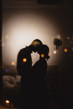 Reflective Of Loving Couple Kissing On Panoramic Window Background With Night Urban View. Romance In The Sky