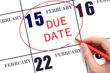 Hand writing text DUE DATE on calendar date February 15 and circling it. Payment due date