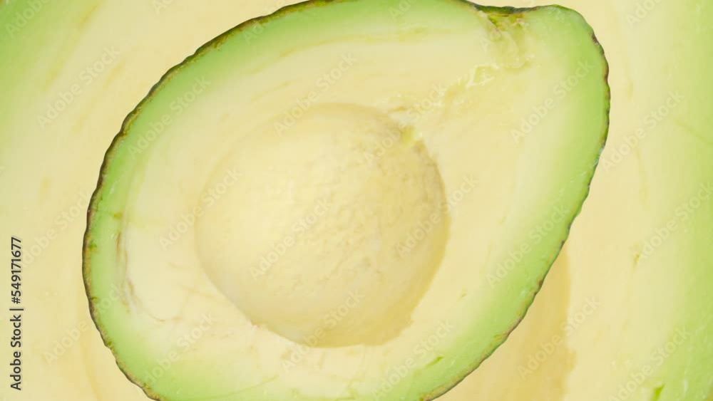 Poster zooming half of avocado in seamless loop background. exotic fruits in seamless loop animation. endle