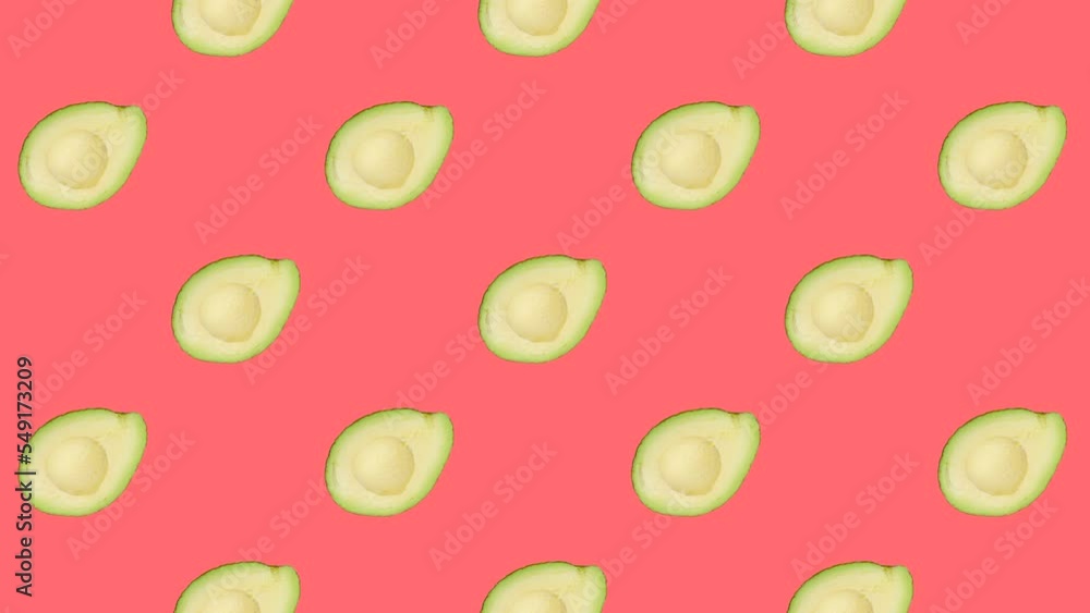 Poster a half of avocado in seamless loop pattern on a coral background. exotic fruits in seamless loop ani