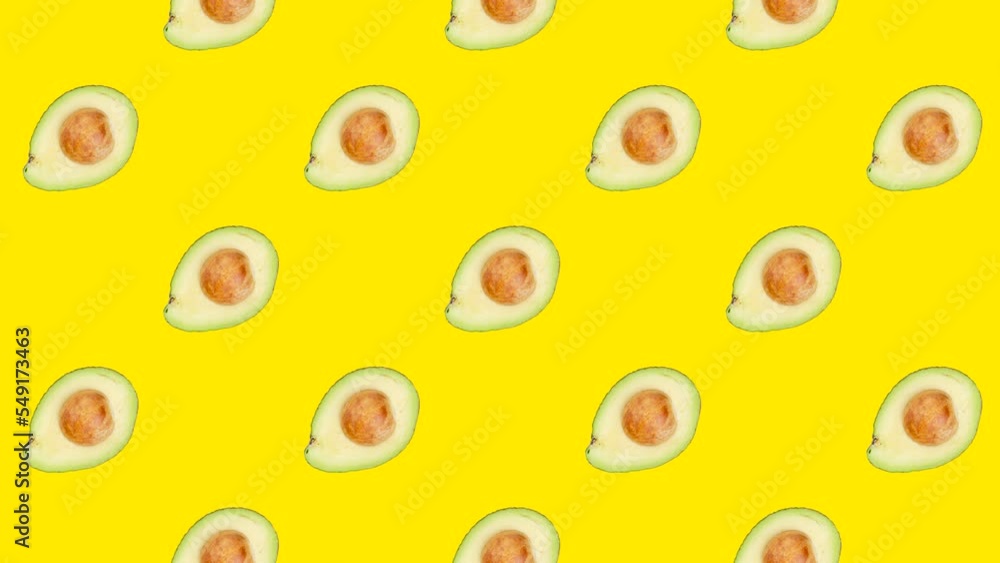 Poster a half of avocado with seed in seamless loop pattern on a yellow background. exotic fruits in seamle